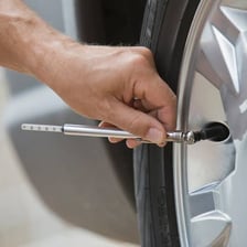 A person using a gauge to measure pressure