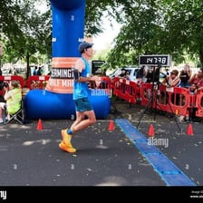 A runner crossing a finish line while a stopwatch records the time