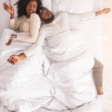 A person sprawled across most of a bed