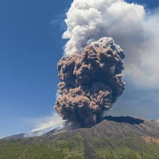 Mount Etna erupting or smoking above the Sicilian landscape