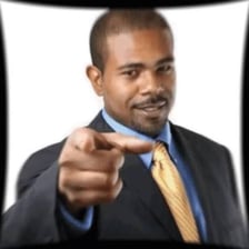 Person pointing toward another person to identify them