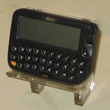 A vintage handheld personal digital assistant with a small screen and physical buttons