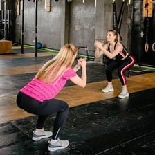 Athletes doing a high-intensity workout with functional exercises in a gym.