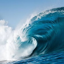 A breaking ocean wave with a clearly defined crest