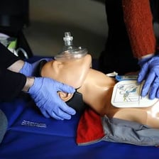 An emergency medical technician practicing CPR