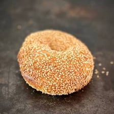 A close-up of sesame seeds on a bagel.