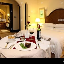 A hotel room alongside a prepared meal representing room and board