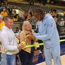 A basketball spectator cheering from the stands.