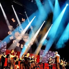 A music band performing in an emo-style concert setting