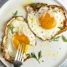 A sunny-side-up egg with a visibly liquid yolk