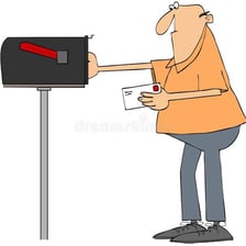 A person placing a stamped letter into a mailbox