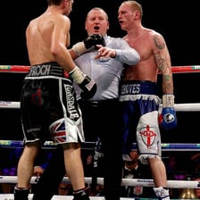 A boxing referee intervening after a knockout