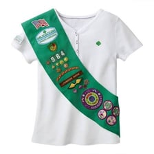 A Girl Scout sash displaying earned badges.