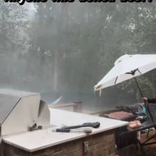 Rain falling on an outdoor barbecue setup