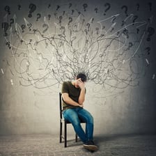 A person sitting alone with a visibly disappointed expression