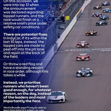 A race car driving around a racetrack.