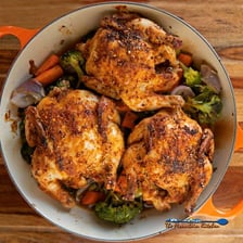 A roasted Cornish game hen served on a plate