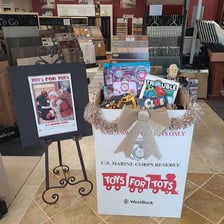 A Toys for Tots collection box filled with donated toys