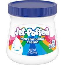 A jar of white marshmallow spread with a spoon