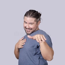 A person smiling bashfully after receiving a compliment.