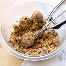Unbaked cookie dough in a mixing bowl.