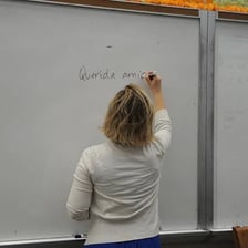 A female teacher standing in a Spanish-language classroom