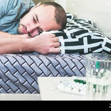 A person resting in bed while ill.