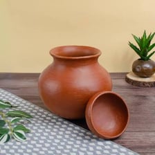A reddish-brown terracotta clay pot