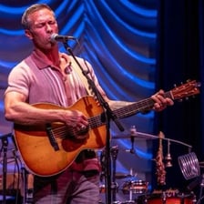 A musician performing at a temporary live engagement
