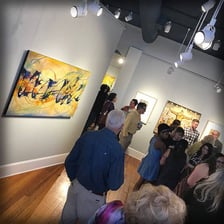 An art gallery displaying paintings in an exhibition