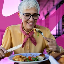 A person enthusiastically eating a large meal