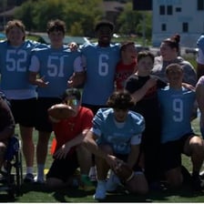 A group of athletes stands together as a team.