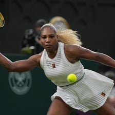 A tennis player celebrating after winning a match