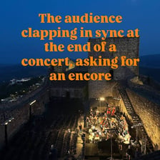 A concert audience applauding after a performance