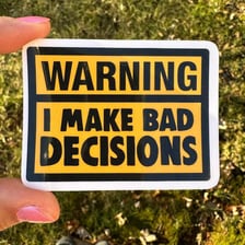 A person hesitating beside a visual warning about a bad decision