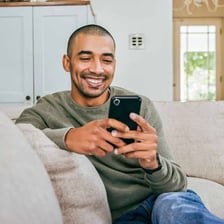 A person using a smartphone to send a text message.