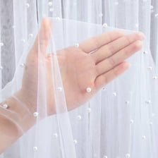 A translucent gauzy veil made of lightweight fabric