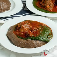 Fresh yams beside a bowl of amala
