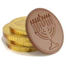 Gold-foil chocolate coins beside a Hanukkah dreidel