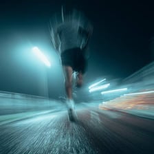 A runner captured with motion blur to suggest high speed.