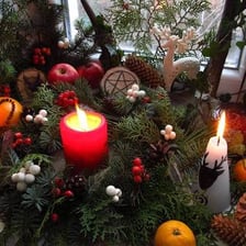 A winter solstice celebration with evergreen decorations and firelight