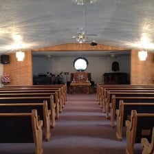 A church interior viewed down the central aisle.