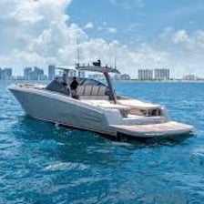 A white luxury yacht cruising on a sunny ocean