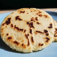 A round Colombian arepa made from cornmeal.
