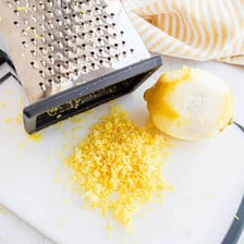 A grater producing fine zest from the peel of a lemon.