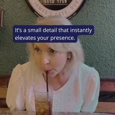 A person taking a small sip from a glass.