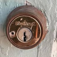 A close-up view of a lock showing signs of tampering.