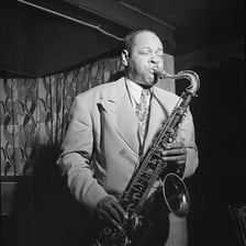 Coleman Hawkins performing on a tenor saxophone