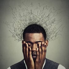A person looking worried while thinking about a problem