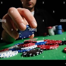 Poker players putting chips into a central pot